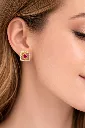 Elegant gold and ruby earring close-up.webp